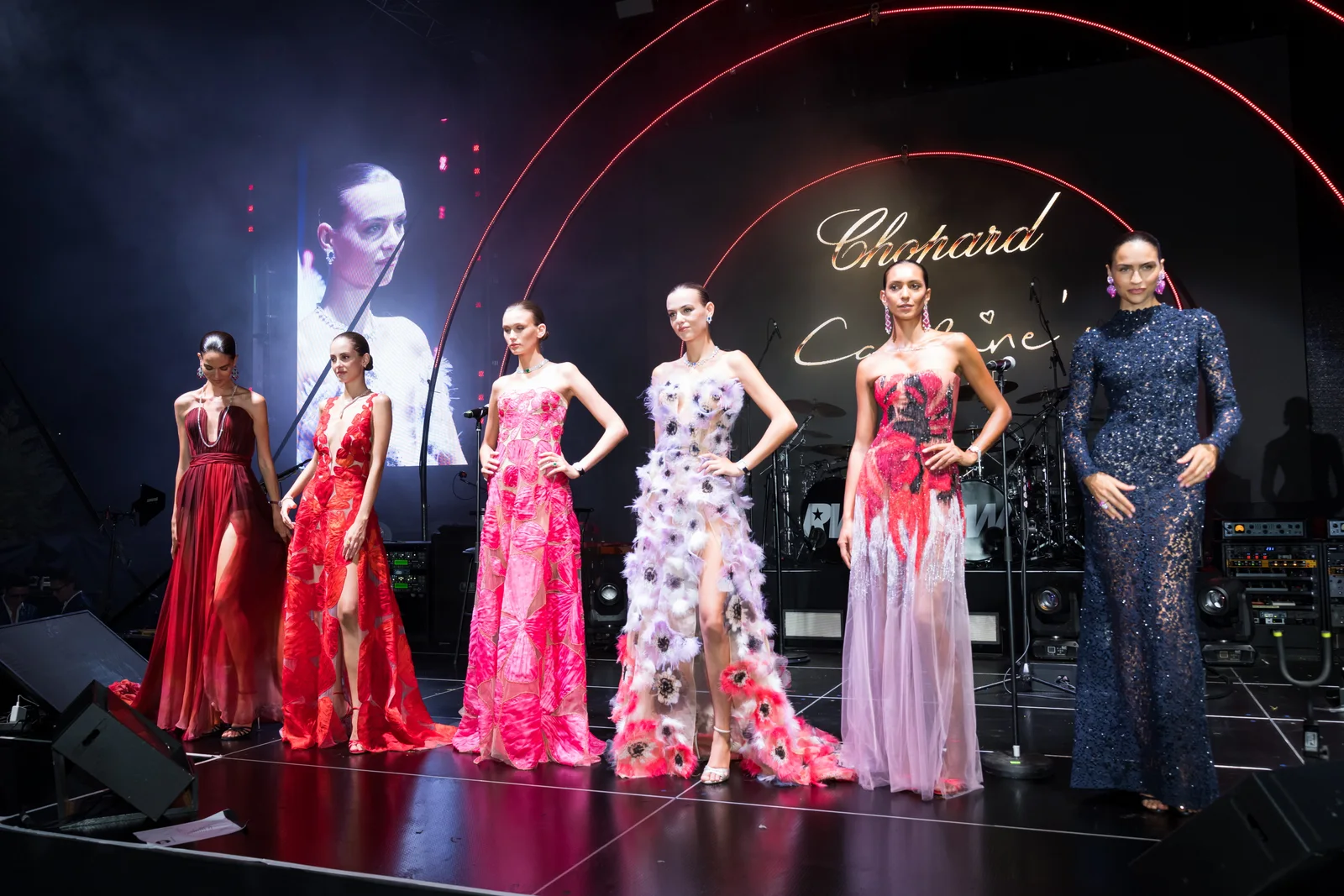 Models present gowns from the Chopard and Caroline's Couture showcase on the BIG ART Festival stage